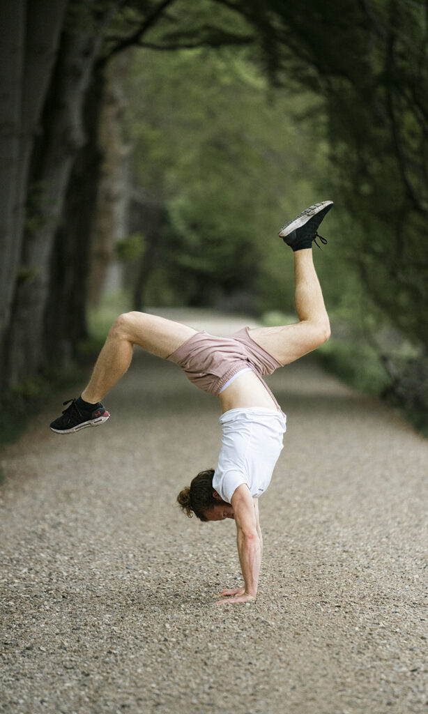 a man doing a handstand on a path